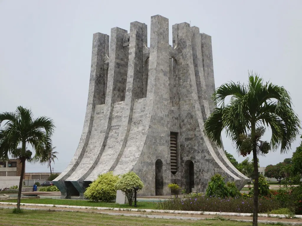 Mausoléu de Kwame Nkrumah, em Acra, uma torre de mármore em forma de leque entre palmeiras.