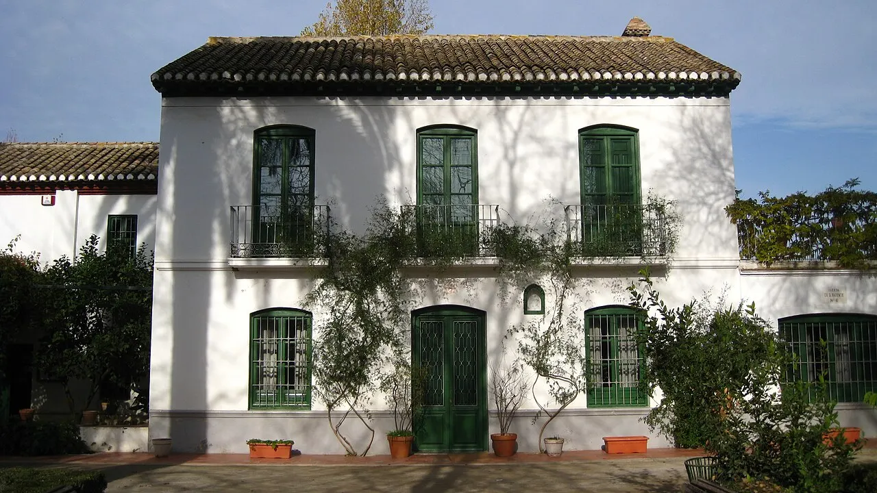 The García Lorca family's summer house at Huerta de San Vicente: two whitewashed storeys, green windows and doors and climbers on the façade.