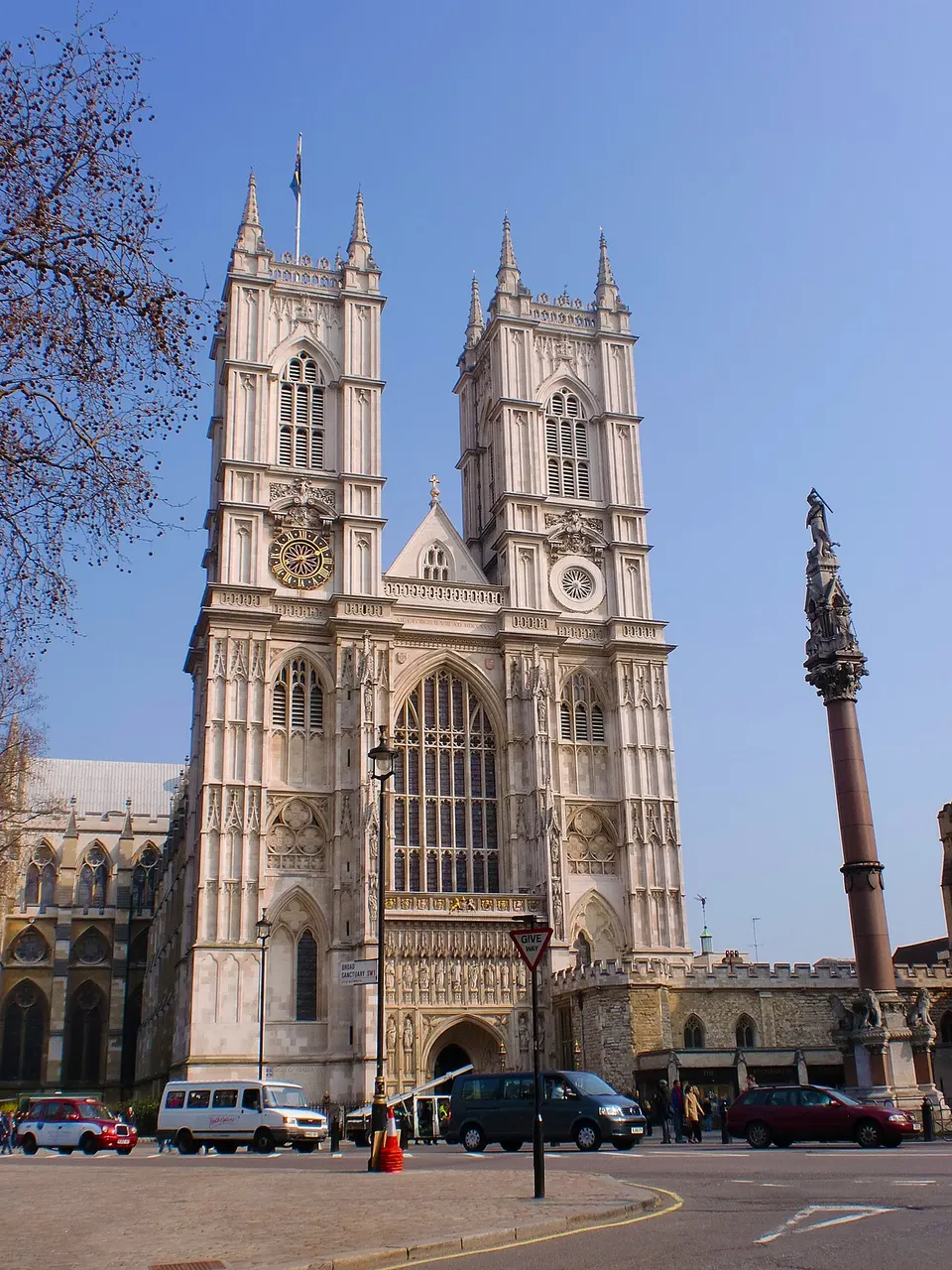 Fachada oeste gótica da Abadia de Westminster, em Londres, com as duas torres, sob céu azul.
