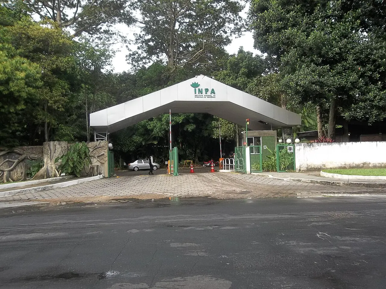 Portal de entrada del Instituto Nacional de Investigaciones de la Amazonia, en Manaos, con cubierta blanca y garita.
