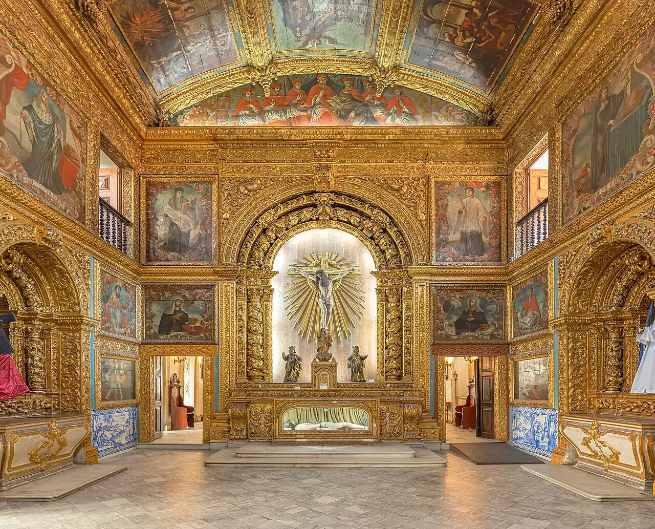 L'intérieur de la Chapelle dorée, aux murs et au plafond couverts de boiseries dorées et de peintures, avec l'autel éclairé au fond.