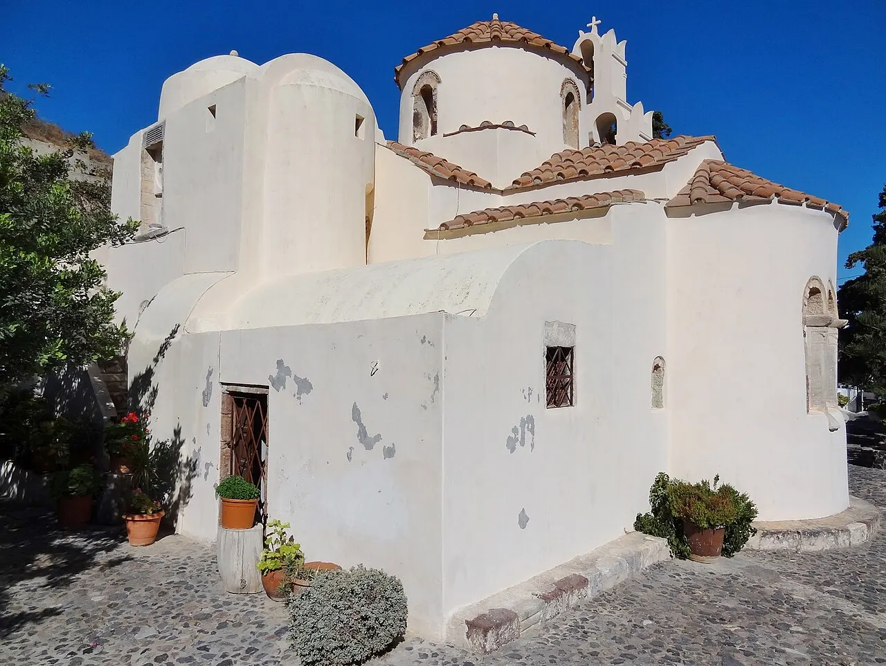 Igreja bizantina da Panagia Episkopi, em Mesa Gonia, caiada de branco, com telhado de pedra e cúpula.