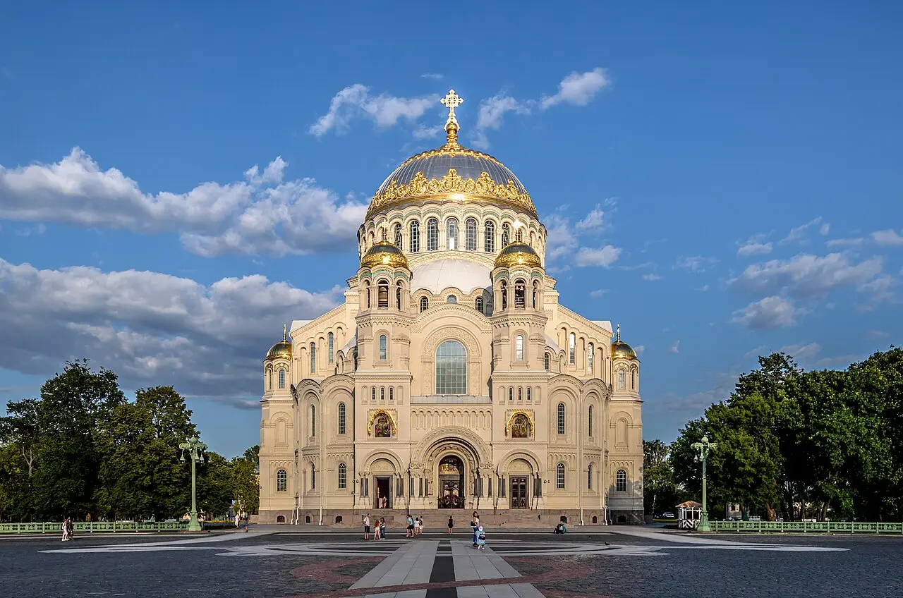A Catedral Naval de São Nicolau, em Kronstadt, de pedra clara com cúpula central dourada e cúpulas menores, numa praça ampla com poucos visitantes.