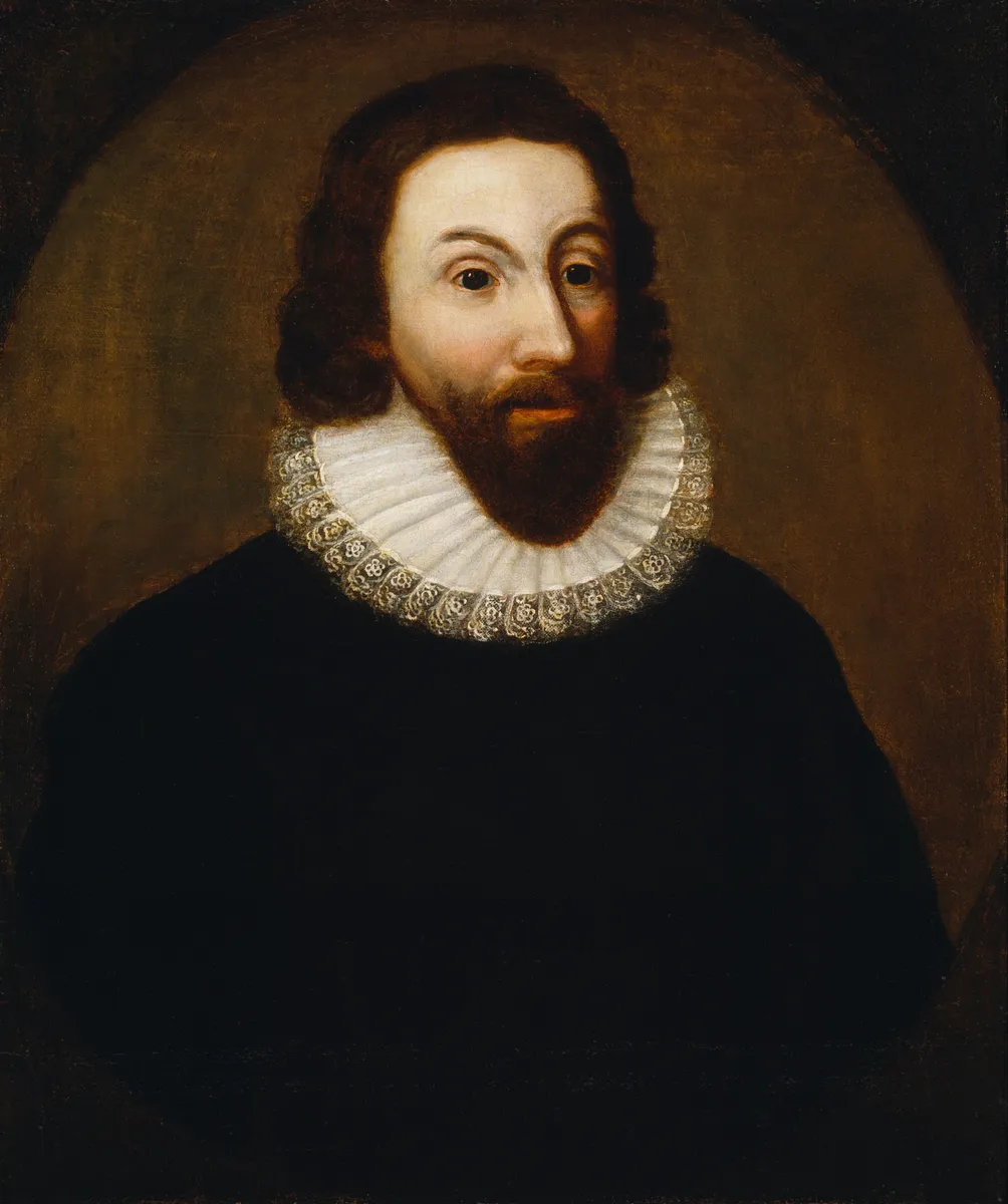 Retrato de um homem com cabelos escuros, bigode, barba, gola branca e roupa preta contra fundo castanho.