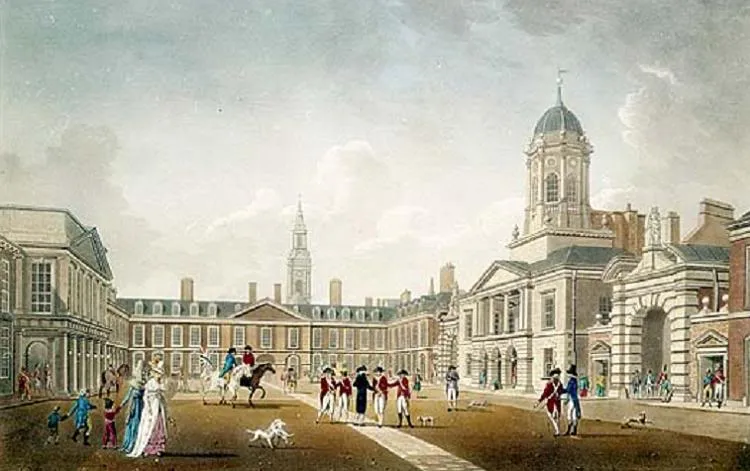 View of Dublin Castle’s courtyard, with buildings, columns, a tower and small figures before the façades.