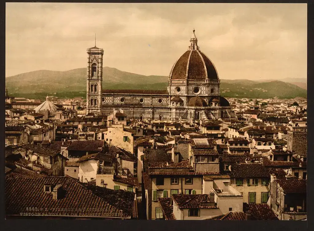 Un photochrome coloré montre la coupole et le campanile de la cathédrale de Florence s’élevant au-dessus des toits de tuiles de la vieille ville, avec des collines à l’arrière-plan.