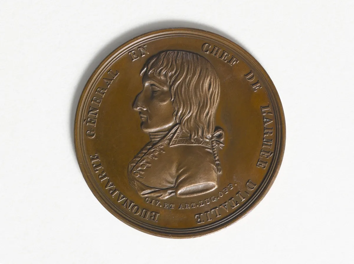 Medalha com busto de Bonaparte de perfil e inscrição sobre o comandante do exército da Itália.