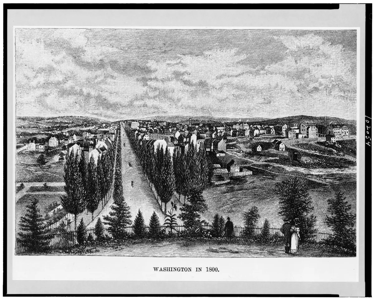 Gravura com estrada, árvores, figuras no primeiro plano, construções ao fundo e título “Washington in 1800” abaixo, com bordas do registro fotográfico.
